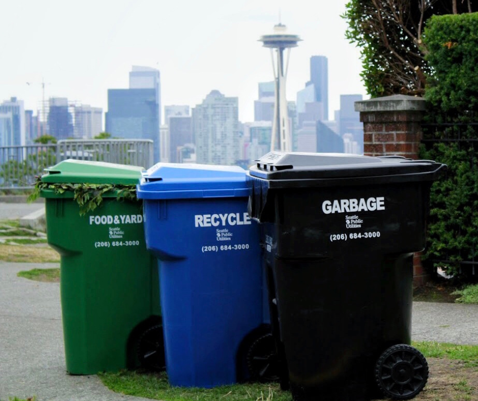 Garbage, recycling, and compost bins with the Space Needle in the background