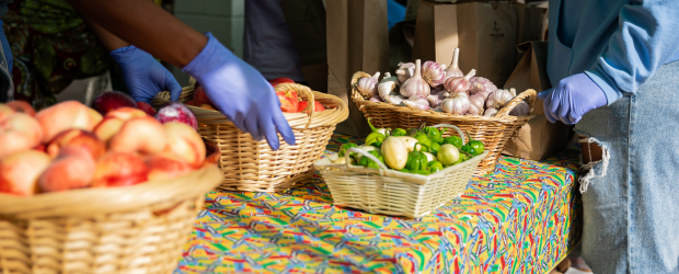 A table of fresh produce in baskets at a market