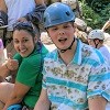 a program participant  in a climbing hard hat and a recreation leader smile at the camera