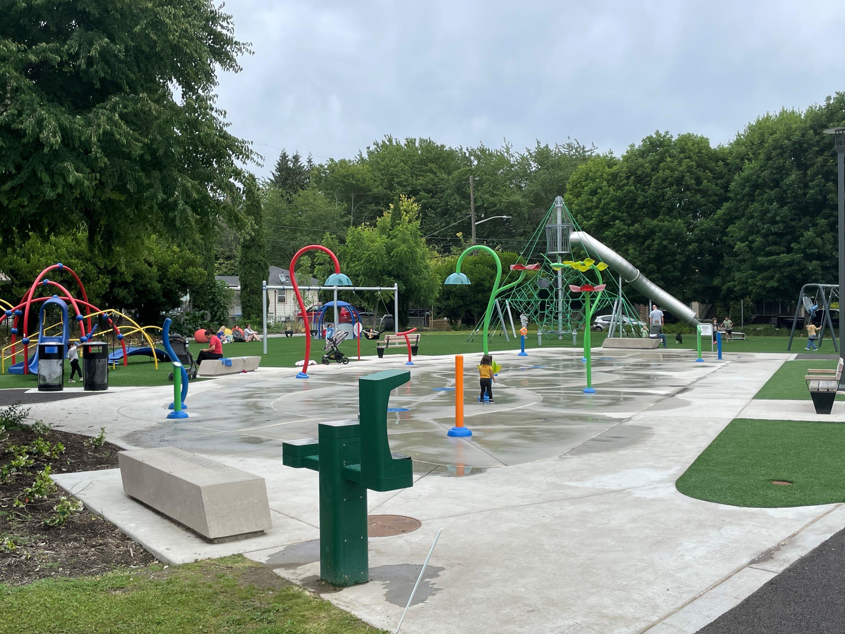 South Park Playground's spraypark, with play equipment in the background