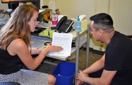 A case working explaining a form to a client