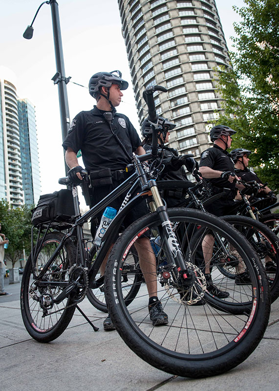 Photo of a policeman stancding next to his bike