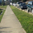 At-grade concrete walkway with wheel stop delineators