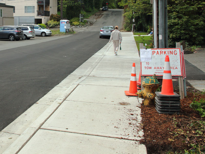 A traditional concrete sidewalk with curbs