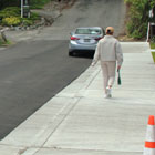 A traditional concrete sidewalk with curbs