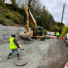 Preparing the road for new asphalt by placing gravel 