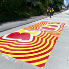 Crew installing red and yellow art, designed by Acila Antonio