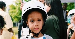 Child wearing a white bike helmet