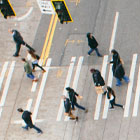 Aerial photo of people walking across a crosswalk in downtown Seattle