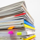 A stack of papers reports against a white background