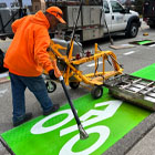 SDOT staff putting down new markings for a protected bike lane