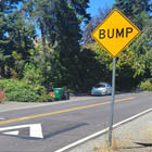 Example of a speed hump that helps you drive the speed limit. It has breaks in the center and edges so that emergency vehicles don’t have to slow down.  