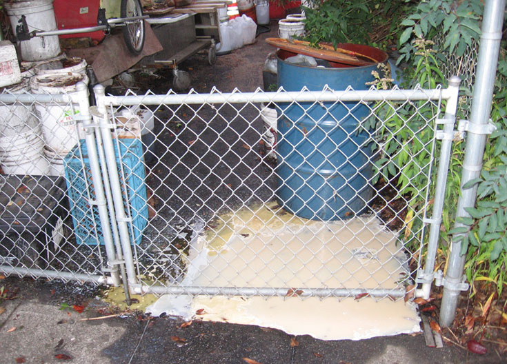 Improper storage of grease and other chemicals resulted in a release to the street and drains.