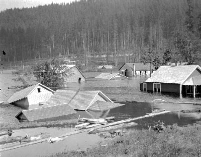 Log-filled floodwaters fill the town of Moncton, submerging some buildings up to their rooflines and causing some buildings to float off of their foundations.