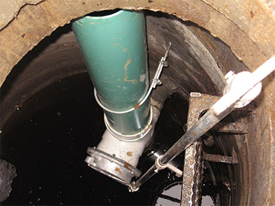 The flow control structure has a small hole at the bottom of the pipe that meters the amount of water that can drain out of the detention system.