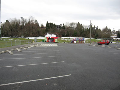 The impervious surfaces on a parcel are the hard cement or concrete surfaces that do not absorb rainfall during a rain event.