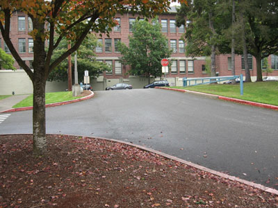 Stormwater flows off these surfaces into nearby catch basins, then into the property's stormwater structure before discharging into the City stormwater system.