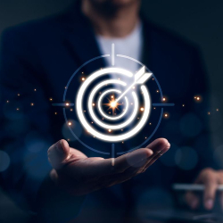 A picture of a bullseye with an arrow in a man's hand