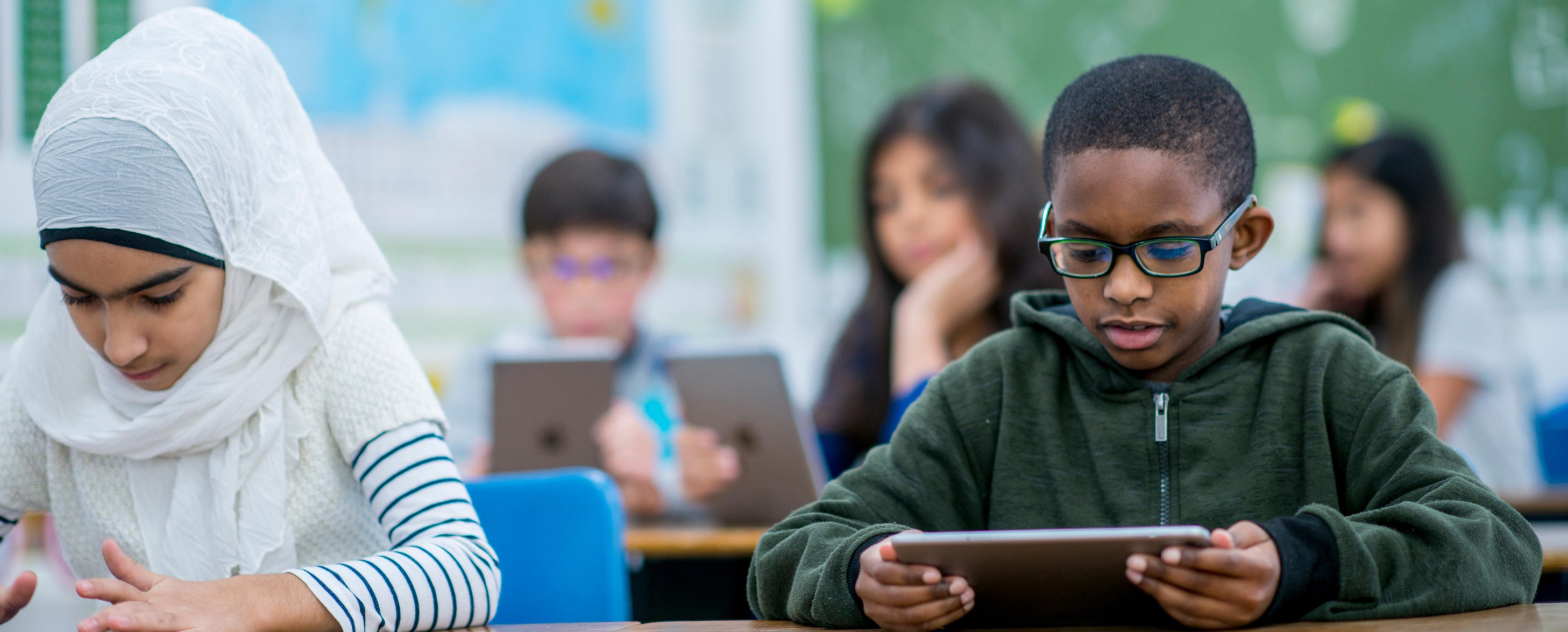 Boy using a tablet in a class.