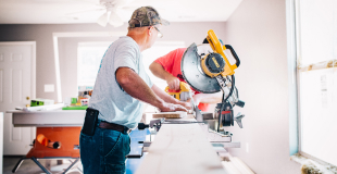 Man cutting wood on a bench saw