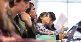 Row of college students sitting in class