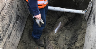 Low shot of someone standing in a side sewer trench