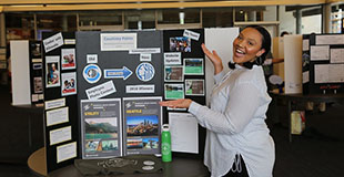 City intern at a job display board.