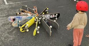 A youth looks at skateboards arranged into a circle on their sides