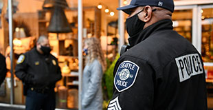 Police officer in front of a downtown store.