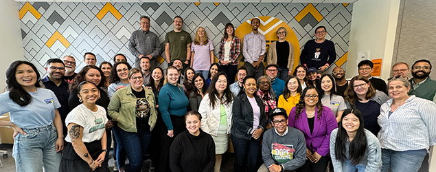 A group of employees stands on stairs