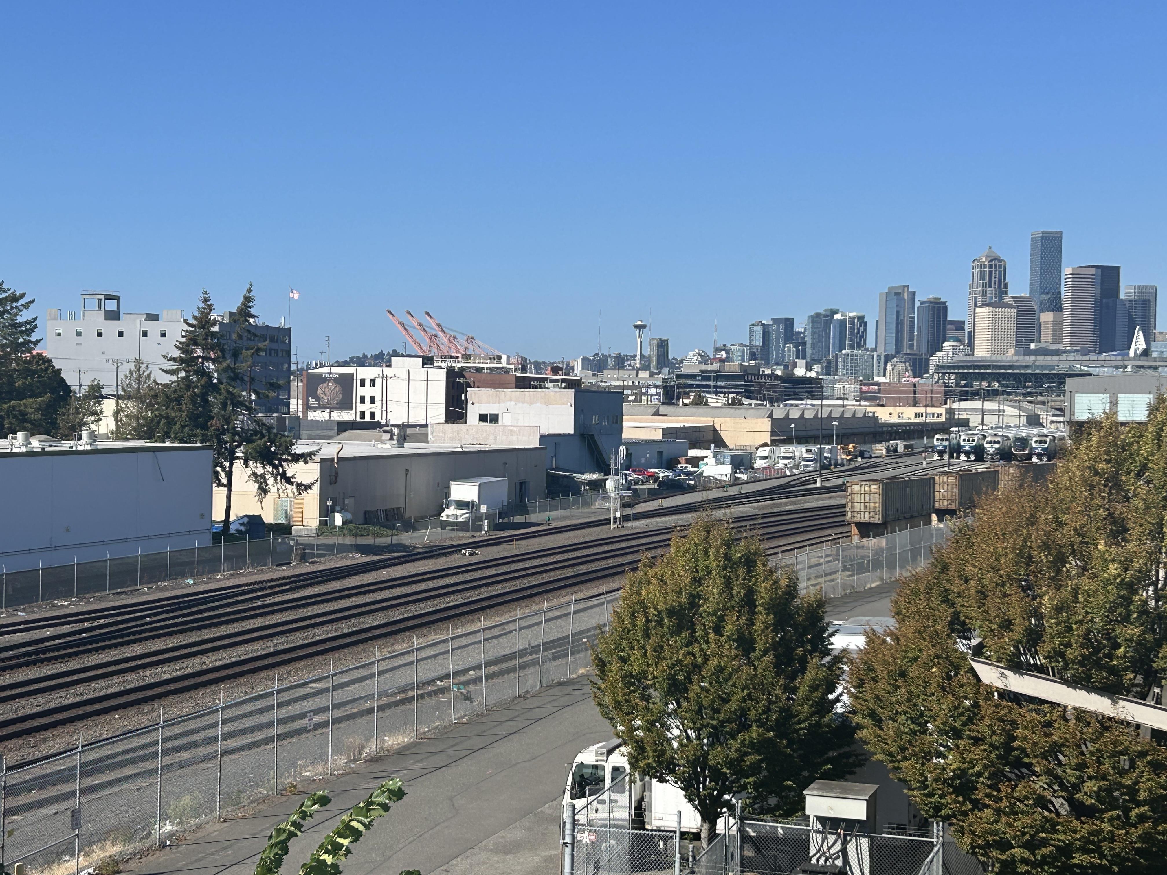 A view of railroads and Seattle skyline.