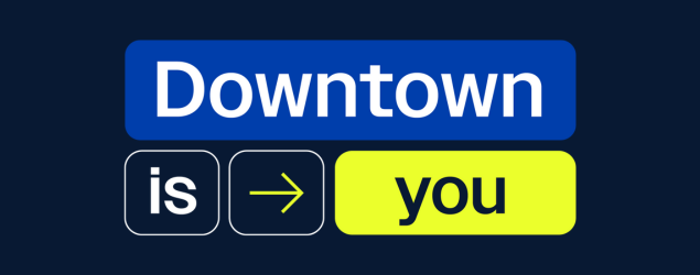 Downtown is you logo on navy background. The logo consists of four rectangular shapes with text in white and navy as well as a yellow arrow pointing towards the word “you.” 