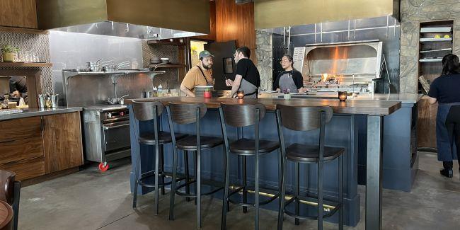 Remodeled restaurant with a few workers in the kitchen