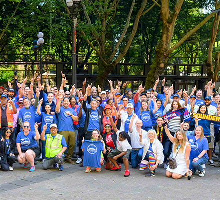 Mayor Harrell joins a large group of volunteers in a park