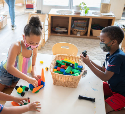 Children in preschool play with blocks