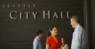 Staff outside Seattle City Hall sign