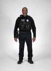 This photo shows a Seattle Police Department Officer with a body-worn camera, a firearm and holster and assorted SPD gear.