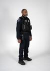 This photo shows a Seattle Police Department Officer wearing tactical gear, with a firearm in holster and a body-worn camera, turned to the left.