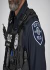 A close-up photo of a Seattle Police Department officer's badge and tactical gear.