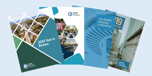 Stack of four annual reports spread out in a line