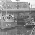 Black and white photo of the dock in use in the 1920s. 