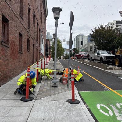 Crew working on a sidewalk on Bell Street