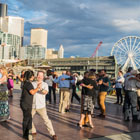 Community members dancing together on Pier 62