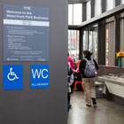 People washing their hands inside the new restroom.  